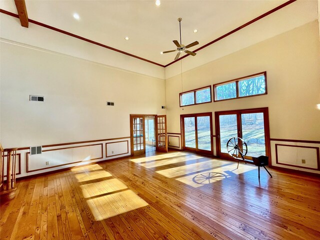 71 Saddleback Ridge Rd, Wallkill, NY 12589 - unfurnished living room featuring hardwood / wood-style flooring, french doors, a ceiling fan, a high ceiling, and a decorative wall