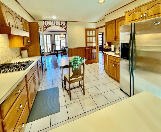 71 Saddleback Ridge Rd, Wallkill, NY 12589 - kitchen with appliances with stainless steel finishes, french doors, a wainscoted wall, brown cabinets, and light countertops