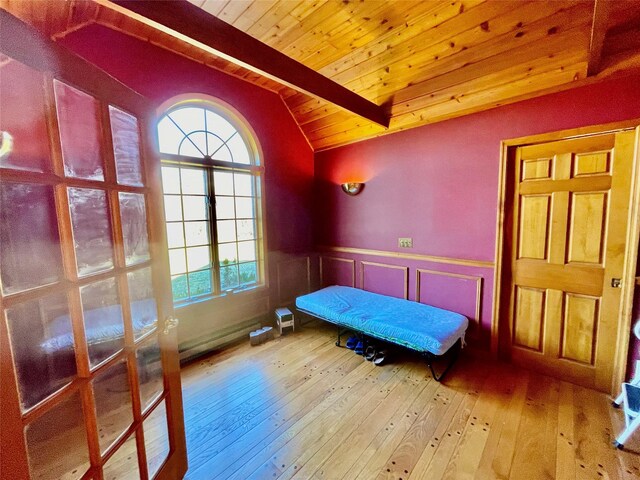 71 Saddleback Ridge Rd, Wallkill, NY 12589 - bedroom featuring hardwood / wood-style floors, wooden ceiling, wainscoting, and a decorative wall