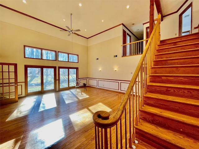 71 Saddleback Ridge Rd, Wallkill, NY 12589 - stairway featuring a decorative wall, a towering ceiling, ceiling fan, wood finished floors, and a wainscoted wall