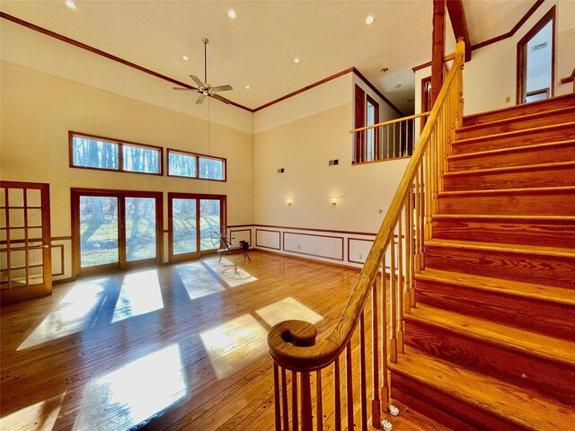 71 Saddleback Ridge Rd, Wallkill, NY 12589 - stairs with a decorative wall, a high ceiling, ceiling fan, wood finished floors, and wainscoting