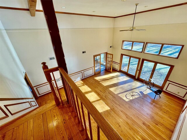 71 Saddleback Ridge Rd, Wallkill, NY 12589 - stairway with hardwood / wood-style floors, a ceiling fan, a towering ceiling, and ornamental molding