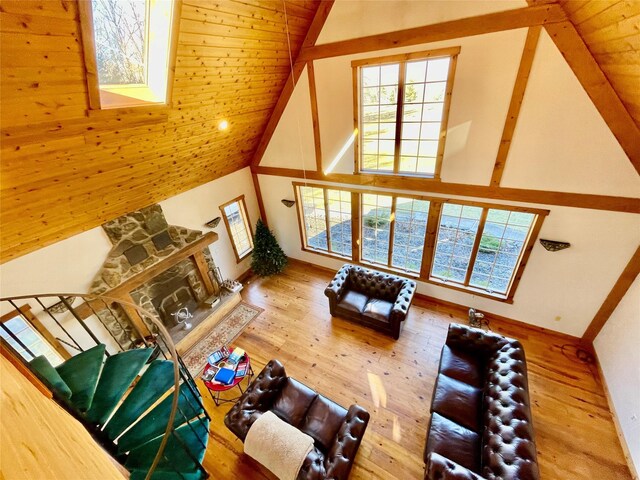 71 Saddleback Ridge Rd, Wallkill, NY 12589 - living room featuring high vaulted ceiling, wood finished floors, wooden ceiling, and a stone fireplace
