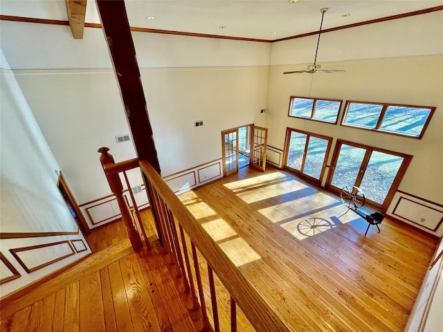 71 Saddleback Ridge Rd, Wallkill, NY 12589 - stairs with hardwood / wood-style flooring, baseboard heating, ceiling fan, a towering ceiling, and ornamental molding