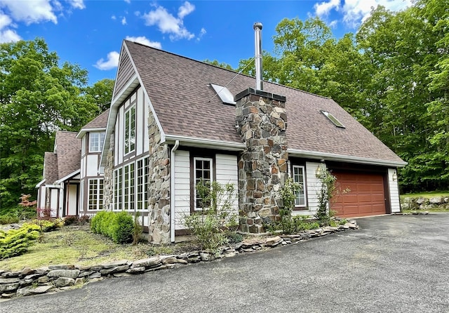 71 Saddleback Ridge Rd, Wallkill, NY 12589 - view of front of property with roof with shingles, driveway, a garage, stone siding, and a chimney