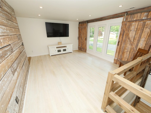 35 Junard Blvd, Port Jefferson Station, NY 11776 - living area featuring wood finished floors, recessed lighting, baseboards, and a barn door