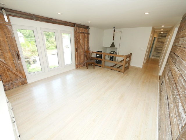35 Junard Blvd, Port Jefferson Station, NY 11776 - living room featuring light wood finished floors, a barn door, and recessed lighting