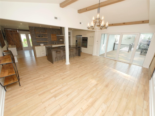 35 Junard Blvd, Port Jefferson Station, NY 11776 - unfurnished living room with a chandelier, beamed ceiling, a sink, light wood-type flooring, and high vaulted ceiling