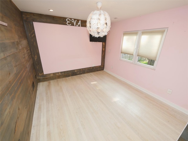 35 Junard Blvd, Port Jefferson Station, NY 11776 - spare room featuring a chandelier, wood finished floors, and baseboards
