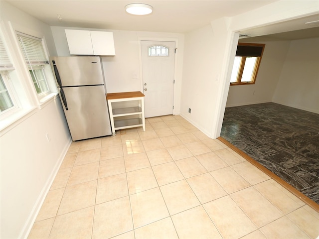 35 Junard Blvd, Port Jefferson Station, NY 11776 - kitchen with freestanding refrigerator, white cabinets, and baseboards