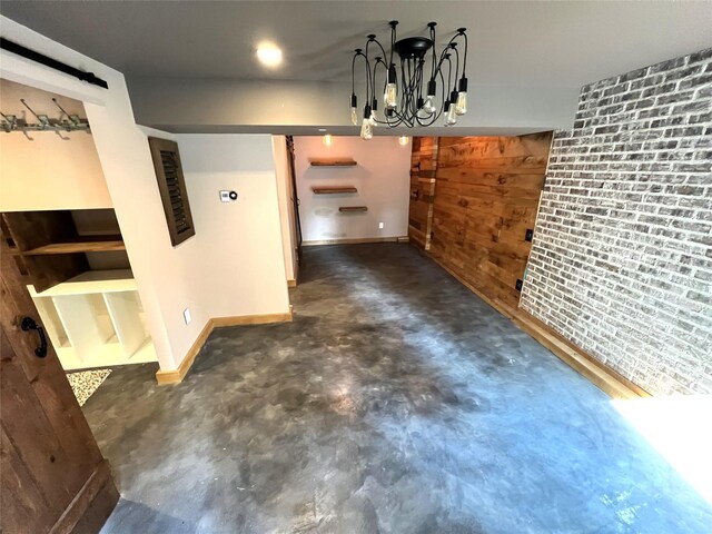 35 Junard Blvd, Port Jefferson Station, NY 11776 - unfurnished dining area with a barn door, concrete floors, baseboards, and a chandelier