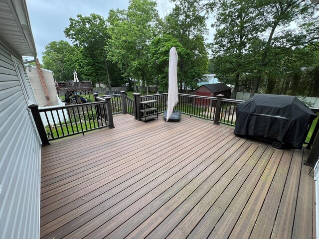 35 Junard Blvd, Port Jefferson Station, NY 11776 - wooden terrace featuring a grill and view of wooded area