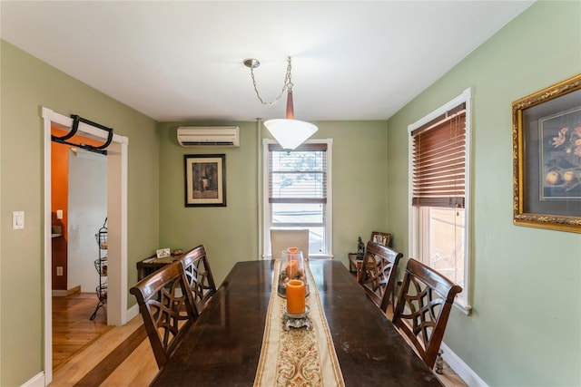 45 4th St, Valley Stream, NY 11581 - dining room featuring an AC wall unit and wood finished floors