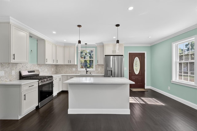104 S Quaker Ln, Hyde Park, NY 12538 - kitchen featuring appliances with stainless steel finishes, healthy amount of natural light, dark wood-style floors, crown molding, and recessed lighting