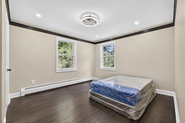 104 S Quaker Ln, Hyde Park, NY 12538 - bedroom featuring baseboard heating, ornamental molding, wood finished floors, and recessed lighting