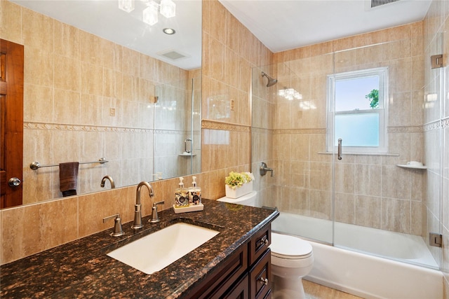82 Cherry Ln, Lynbrook, NY 11563 - bathroom featuring tile walls, vanity, enclosed tub / shower combo, and backsplash