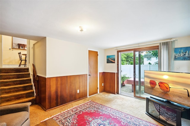 82 Cherry Ln, Lynbrook, NY 11563 - living room with a wainscoted wall, wood walls, and stairs