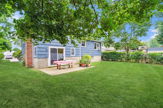 82 Cherry Ln, Lynbrook, NY 11563 - rear view of house with a lawn and a patio