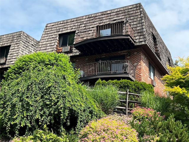 7-05 Briarcliff Dr S, Ossining, NY 10562 - view of front of property featuring brick siding, a balcony, and mansard roof