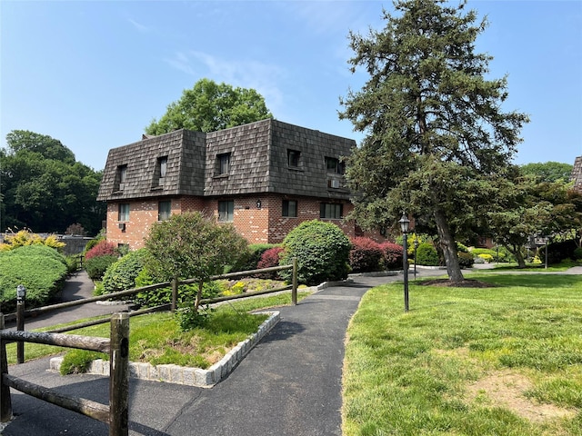 7-05 Briarcliff Dr S, Ossining, NY 10562 - view of front facade with brick siding, mansard roof, and a front yard