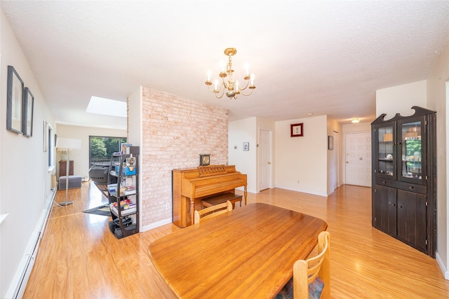 7-05 Briarcliff Dr S, Ossining, NY 10562 - dining space featuring light wood-type flooring, a chandelier, baseboards, and a skylight