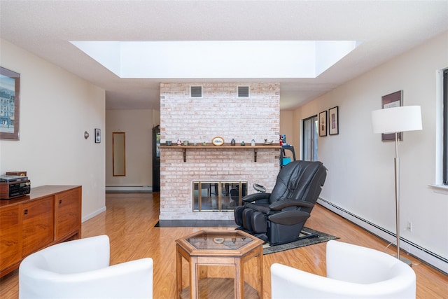 7-05 Briarcliff Dr S, Ossining, NY 10562 - living area featuring a skylight, a baseboard radiator, and light wood-style flooring