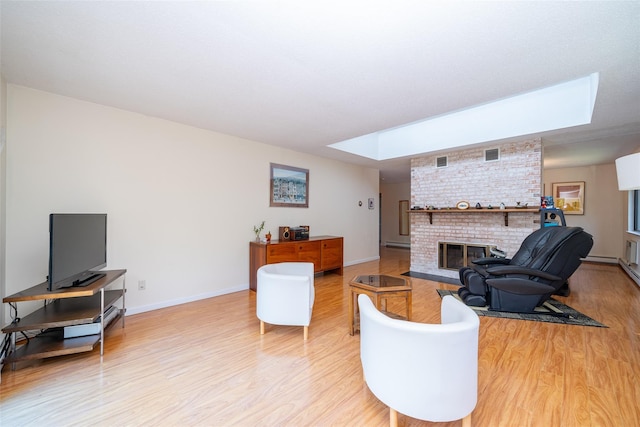 7-05 Briarcliff Dr S, Ossining, NY 10562 - living area featuring a skylight, a fireplace, light wood-type flooring, and baseboards