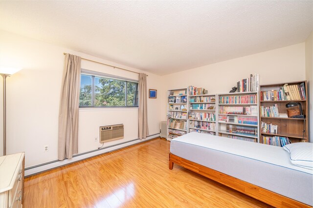 7-05 Briarcliff Dr S, Ossining, NY 10562 - living area featuring baseboard heating, light wood-style flooring, and a wall mounted air conditioner