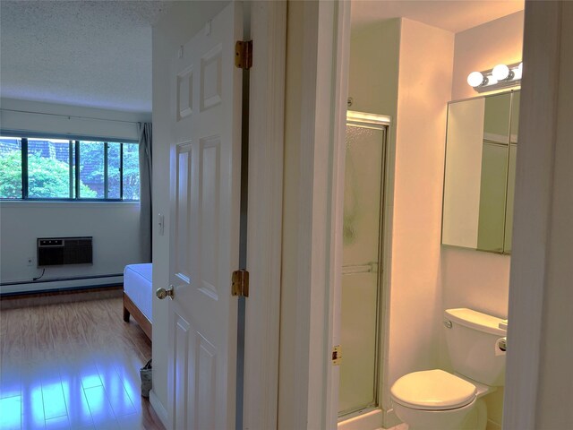 7-05 Briarcliff Dr S, Ossining, NY 10562 - full bathroom with a baseboard radiator, a shower stall, toilet, and a wall mounted air conditioner