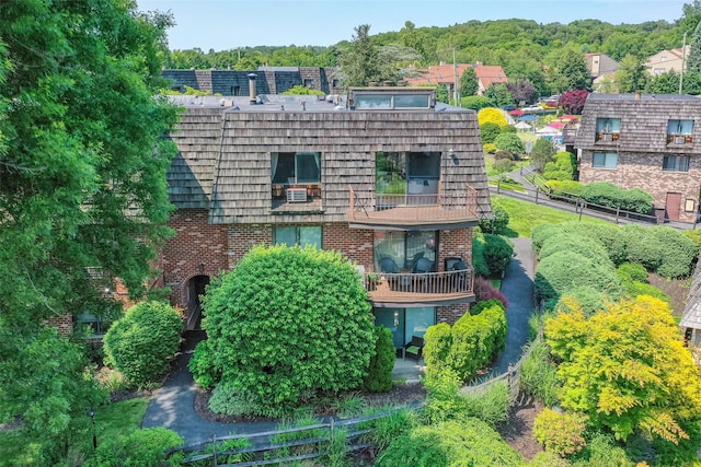 7-05 Briarcliff Dr S, Ossining, NY 10562 - rear view of house featuring brick siding, a balcony, and mansard roof