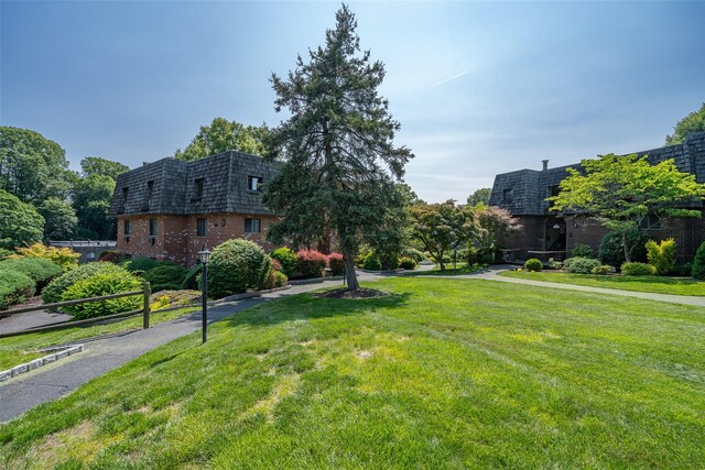 7-05 Briarcliff Dr S, Ossining, NY 10562 - front facade featuring mansard roof, brick siding, and a front lawn