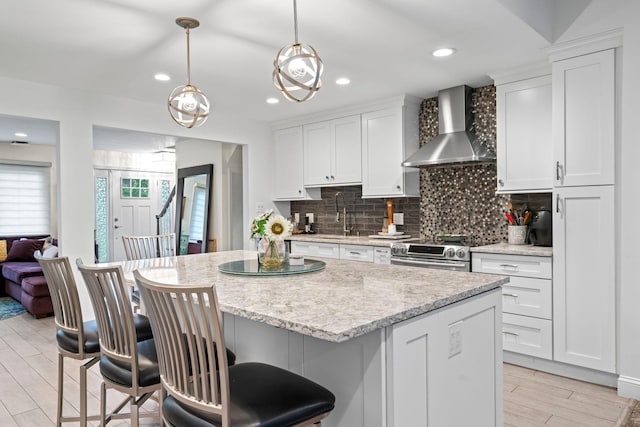 183 Iceland Dr, South Huntington, NY 11746 - kitchen with wall chimney exhaust hood, electric stove, tasteful backsplash, white cabinets, and a kitchen bar