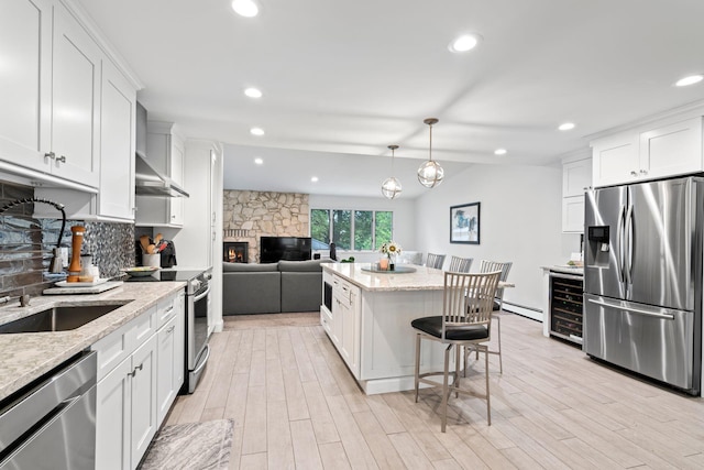 183 Iceland Dr, South Huntington, NY 11746 - kitchen featuring appliances with stainless steel finishes, a sink, beverage cooler, decorative backsplash, and white cabinets