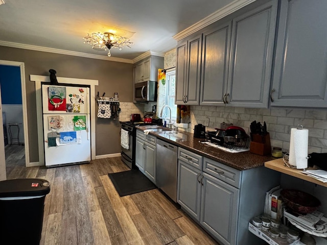 2 Paulding St, Huntington, NY 11743 - kitchen with appliances with stainless steel finishes, gray cabinets, decorative backsplash, wood finished floors, and a sink