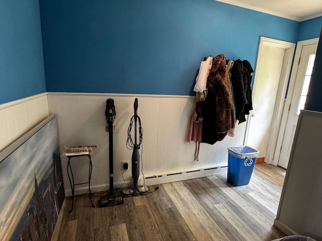2 Paulding St, Huntington, NY 11743 - interior space with wood finished floors, a baseboard radiator, a wainscoted wall, and ornamental molding