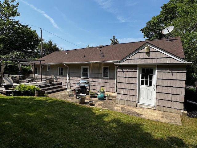 2 Paulding St, Huntington, NY 11743 - rear view of property featuring a lawn, a patio area, and roof with shingles