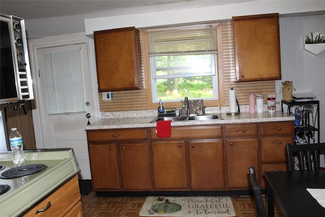 104 Maple Ave, Bethel, NY 12749 - kitchen featuring a sink, brown cabinets, light countertops, and electric cooktop