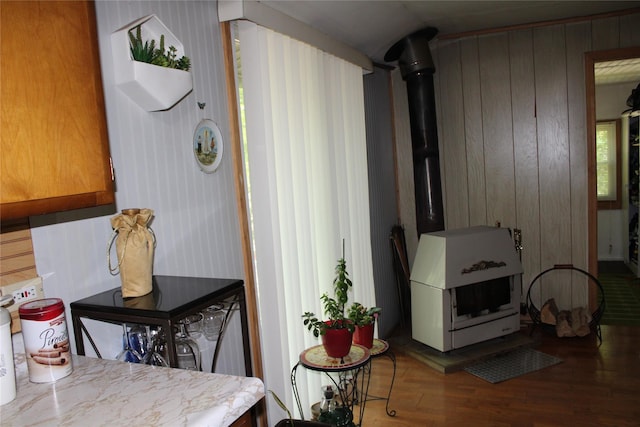 104 Maple Ave, Bethel, NY 12749 - dining space featuring a wood stove, wood finished floors, and wooden walls