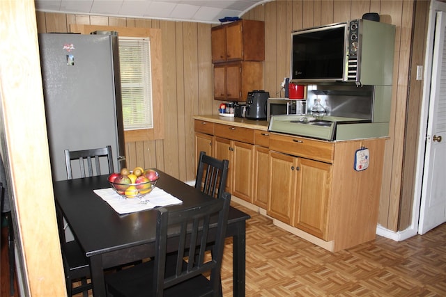 104 Maple Ave, Bethel, NY 12749 - kitchen with stainless steel appliances, wooden walls, and light countertops