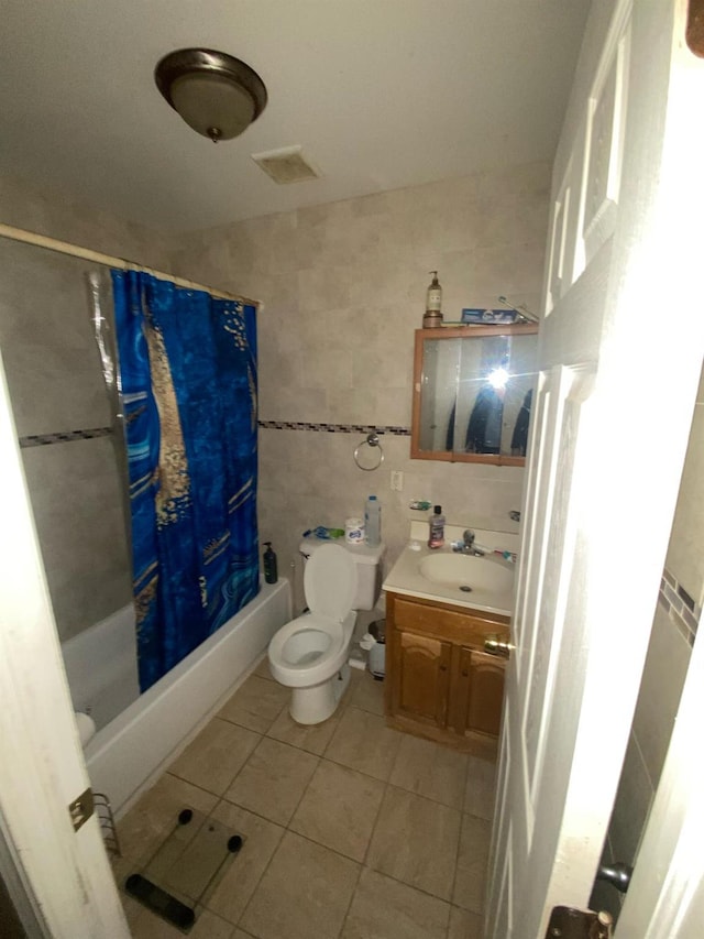 1457 Rosedale Ave, Bronx, NY 10460 - full bath with tile walls, tile patterned floors, vanity, shower / bathtub combination with curtain, and toilet