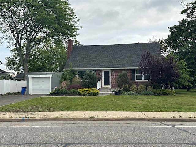 417 S Ocean Ave, Patchogue, NY 11772 - cape cod home with asphalt driveway, roof with shingles, brick siding, and a chimney