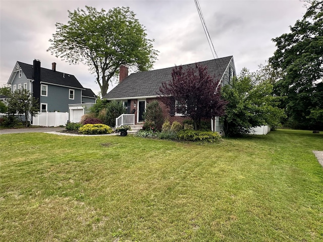 417 S Ocean Ave, Patchogue, NY 11772 - view of front facade featuring a garage, asphalt driveway, brick siding, and a chimney