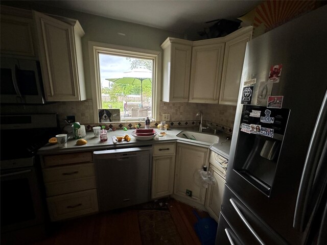 417 S Ocean Ave, Patchogue, NY 11772 - kitchen with appliances with stainless steel finishes, a sink, backsplash, light countertops, and dark wood-style floors