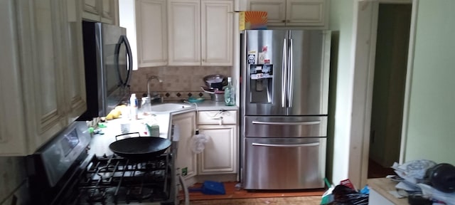 417 S Ocean Ave, Patchogue, NY 11772 - kitchen featuring stainless steel fridge, light countertops, a sink, and gas range oven