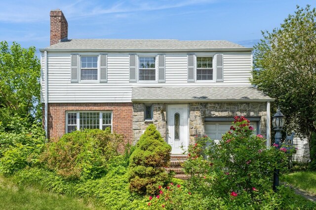16249 13th Ave, Beechhurst, NY 11357 - view of front of home with a chimney, a shingled roof, a garage, and stone siding