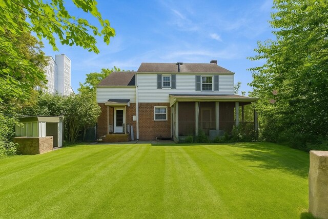 16249 13th Ave, Beechhurst, NY 11357 - rear view of house featuring a lawn, brick siding, a sunroom, and entry steps