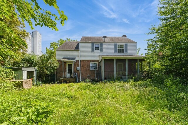 16249 13th Ave, Beechhurst, NY 11357 - back of house featuring brick siding and a sunroom