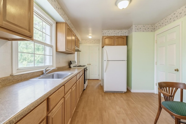 16249 13th Ave, Beechhurst, NY 11357 - kitchen with white appliances, a sink, light countertops, light wood-style flooring, and baseboards