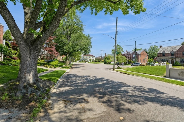 16249 13th Ave, Beechhurst, NY 11357 - view of asphalt street featuring a residential view, street lighting, sidewalks, and curbs