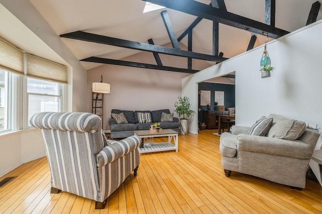 405 Waukena Ave, Oceanside, NY 11572 - living area featuring hardwood / wood-style flooring, beam ceiling, high vaulted ceiling, and a skylight